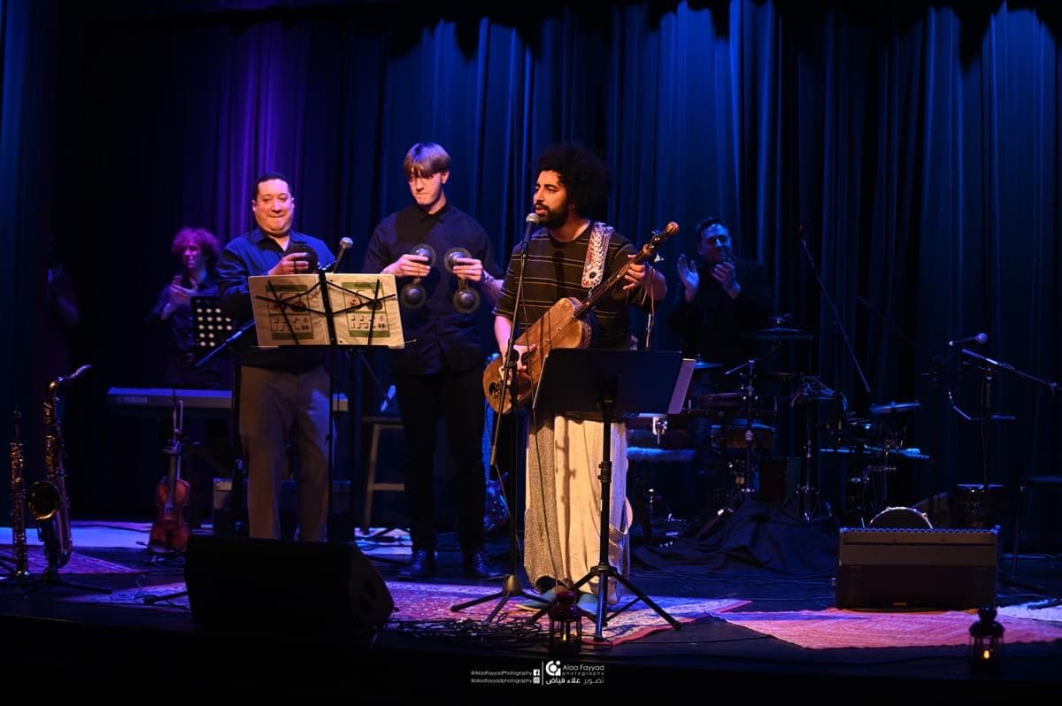 Amine performing with musicians
